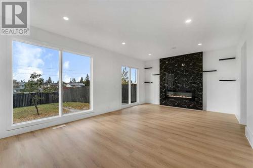 256 Abinger Crescent Ne, Calgary, AB - Indoor Photo Showing Living Room With Fireplace