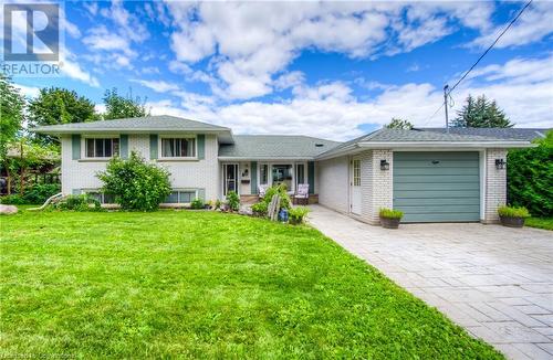 Tri-level home featuring a front yard and a garage - 8 Gerrard Avenue, Cambridge, ON - Outdoor With Facade