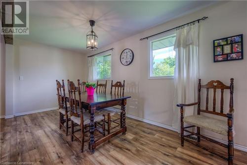 Dining area with wood-type flooring, an inviting chandelier, and a wealth of natural light - 8 Gerrard Avenue, Cambridge, ON - Indoor Photo Showing Dining Room