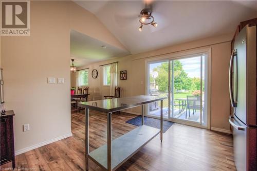 Kitchen featuring ceiling fan, stainless steel fridge, light wood-type flooring, and vaulted ceiling - 8 Gerrard Avenue, Cambridge, ON - Indoor