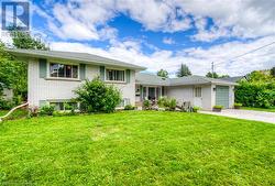 Split level home featuring a front yard and a garage - 