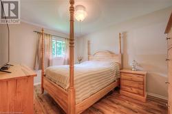 Bedroom featuring dark hardwood / wood-style floors and ceiling fan - 