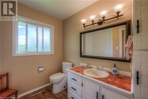 Bathroom featuring wood-type flooring, vanity, and toilet - 8 Gerrard Avenue, Cambridge, ON - Indoor Photo Showing Bathroom