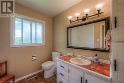 Bathroom featuring wood-type flooring, vanity, and toilet - 