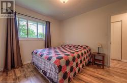 Bedroom with light hardwood / wood-style flooring and ceiling fan - 