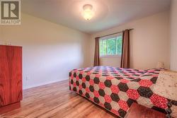 Bedroom with light wood-type flooring - 