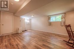 Basement with light wood-type flooring - 