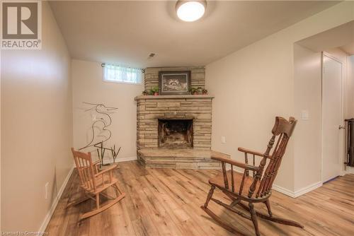 Living area with a fireplace and light hardwood / wood-style flooring - 8 Gerrard Avenue, Cambridge, ON - Indoor With Fireplace