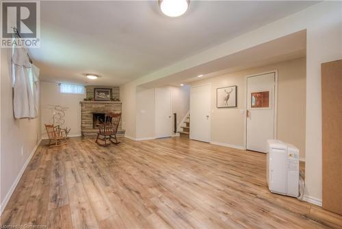 Unfurnished living room with a stone fireplace and light hardwood / wood-style floors - 8 Gerrard Avenue, Cambridge, ON - Indoor With Fireplace