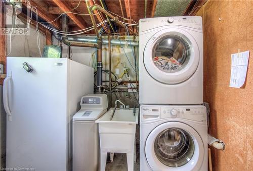 Laundry area with sink and stacked washing maching and dryer - 8 Gerrard Avenue, Cambridge, ON - Indoor Photo Showing Laundry Room