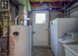 Utilities featuring washer / dryer, sink, and water heater - 