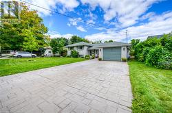 View of front of house with a front yard and a garage - 