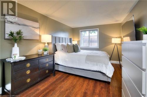 Bedroom with dark wood-type flooring - 276 Eiwo Court Unit# 105, Waterloo, ON - Indoor Photo Showing Bedroom