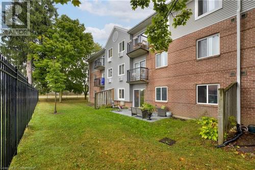 View of building exterior - 276 Eiwo Court Unit# 105, Waterloo, ON - Outdoor With Exterior