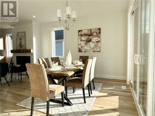 Dining space with light wood-type flooring and a notable chandelier - 53 Giles Street, London, ON - Indoor Photo Showing Dining Room