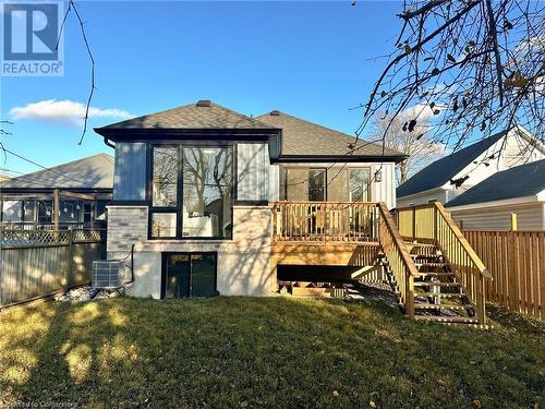 Back of property featuring central AC, a wooden deck, and a lawn - 53 Giles Street, London, ON - Outdoor