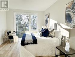 Bedroom with hardwood / wood-style flooring - 