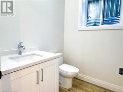 Bathroom with wood-type flooring, vanity, and toilet - 