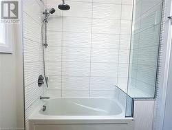 Bathroom with tiled shower / bath combo - 