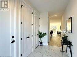 Hallway with light hardwood / wood-style floors - 