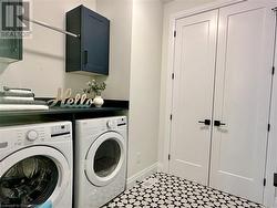 Washroom featuring cabinets and washing machine and clothes dryer - 