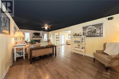 Living room featuring hardwood / wood-style floors, ceiling fan, and a stone fireplace - 9202 9Th Line, Halton Hills, ON - Indoor