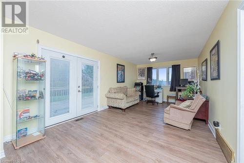 Living room with a textured ceiling, light hardwood / wood-style flooring, and french doors - 9202 9Th Line, Halton Hills, ON - Indoor Photo Showing Living Room