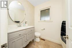 Bathroom with vanity, hardwood / wood-style flooring, and toilet - 