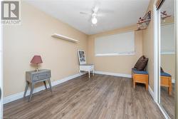 Living area featuring hardwood / wood-style floors and ceiling fan - 