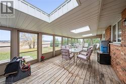 Sunroom / solarium featuring lofted ceiling with skylight - 