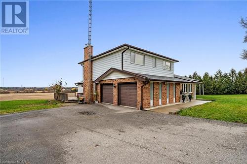 View of front of home featuring covered porch, a garage, and a front lawn - 9202 9Th Line, Halton Hills, ON - Outdoor