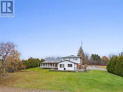 View of front of house with a front yard and a wooden deck - 