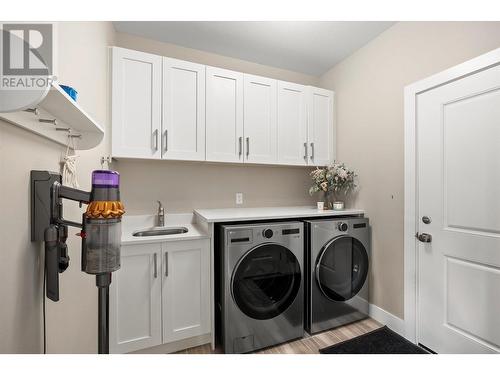 Main floor Laundry Room w/ access to Garage - 1072 Aurora Heights, West Kelowna, BC - Indoor Photo Showing Laundry Room