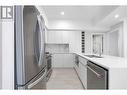 The ceiling is digitally staged; repairs will be completed before closing - 1925 Enterprise Way Unit# 205, Kelowna, BC  - Indoor Photo Showing Kitchen With Stainless Steel Kitchen With Double Sink With Upgraded Kitchen 