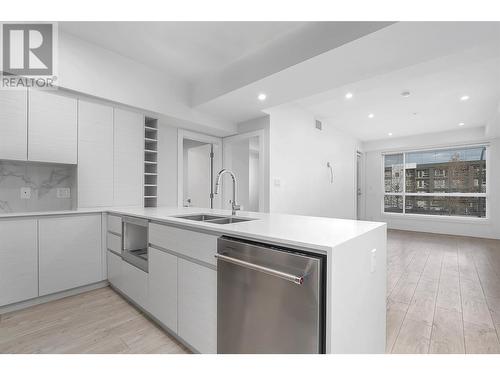 The ceiling is digitally staged; repairs will be completed before closing - 1925 Enterprise Way Unit# 205, Kelowna, BC - Indoor Photo Showing Kitchen With Double Sink With Upgraded Kitchen