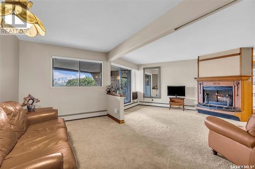 101 222 Saskatchewan Crescent E, Saskatoon, SK - Indoor Photo Showing Living Room With Fireplace