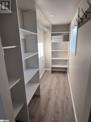 Walk in closet with hardwood / wood-style flooring - 80 Ridley Street, Prince Edward County, ON - Indoor With Storage