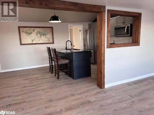 Empty room featuring baseboard heating and dark wood-type flooring - 80 Ridley Street, Prince Edward County, ON - Indoor