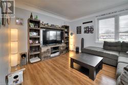 Living room with hardwood / wood-style flooring - 