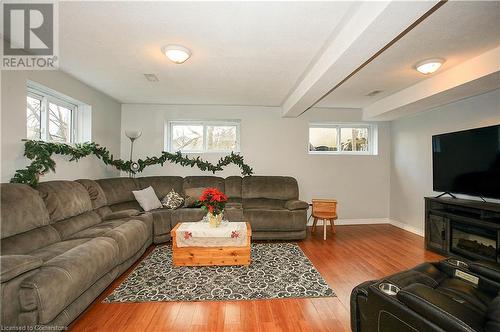 family room featuring beam ceiling, a textured ceiling, hardwood / wood-style flooring, and a healthy amount of sunlight - 220 Bankside Drive, Kitchener, ON - Indoor Photo Showing Living Room