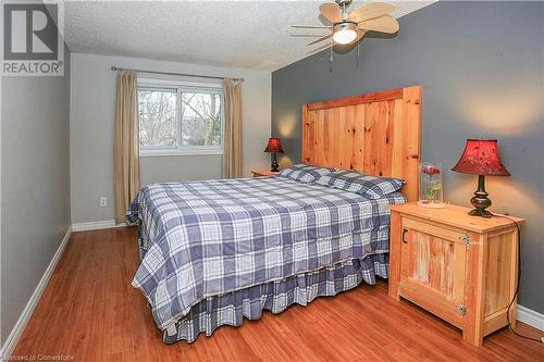 Bedroom featuring wood-type flooring, a textured ceiling, and ceiling fan - 220 Bankside Drive, Kitchener, ON - Indoor Photo Showing Bedroom