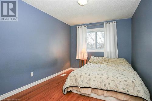 Bedroom with hardwood / wood-style flooring and a textured ceiling - 220 Bankside Drive, Kitchener, ON - Indoor Photo Showing Bedroom