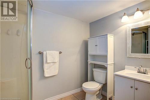 Bathroom featuring tile patterned floors, vanity, toilet, and an enclosed shower - 220 Bankside Drive, Kitchener, ON - Indoor Photo Showing Bathroom