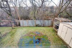 View of yard with green space behind. No rear neighbours. A plastic pool used left a mark on the grass. - 