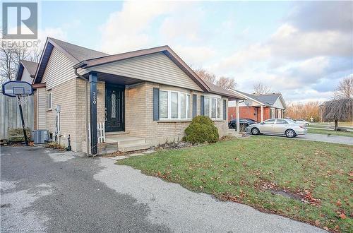 View of front of property featuring cooling unit and a front yard - 220 Bankside Drive, Kitchener, ON - Outdoor