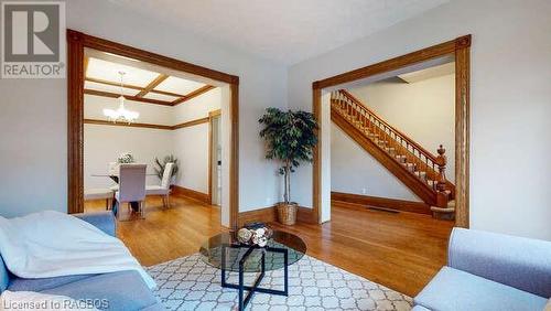 Living room with hardwood / wood-style flooring and a notable chandelier - 550 10Th Street A West, Owen Sound, ON - Indoor Photo Showing Other Room