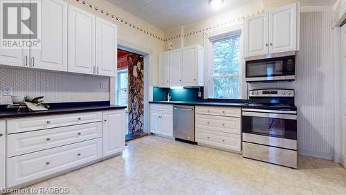 Kitchen with white cabinetry and stainless steel appliances - 550 10Th Street A West, Owen Sound, ON - Indoor Photo Showing Kitchen