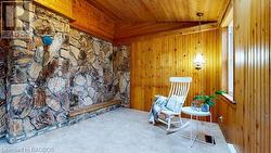 Sitting room with carpet floors, lofted ceiling, wooden walls, and wooden ceiling - 