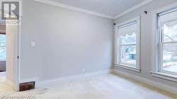 Carpeted spare room with ornamental molding - 