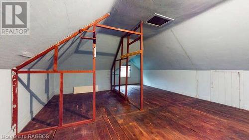 Additional living space featuring dark hardwood / wood-style flooring and vaulted ceiling - 550 10Th Street A West, Owen Sound, ON - Indoor Photo Showing Other Room